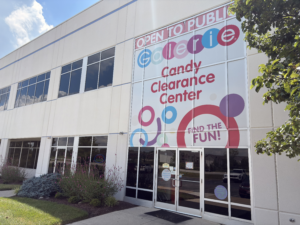 Exterior of the Galerie Candy Clearance Center in Hebron, Kentucky, showing its large colorful storefront sign inviting the public to shop discounted candy.