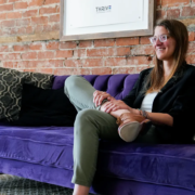 Emily Schubert Emily Schubert, a licensed clinical social worker, sits on a purple couch inside Thrive Empowerment Center in Covington, Kentucky, a trauma-informed LGBTQ-affirming community space focused on safety, healing, and advocacy amid rising anti-LGBTQ+ violence in Northern Kentucky.