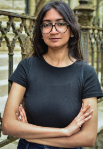 Divya Karthikeyan, Editorial Manager at Queer Kentucky, standing outdoors.