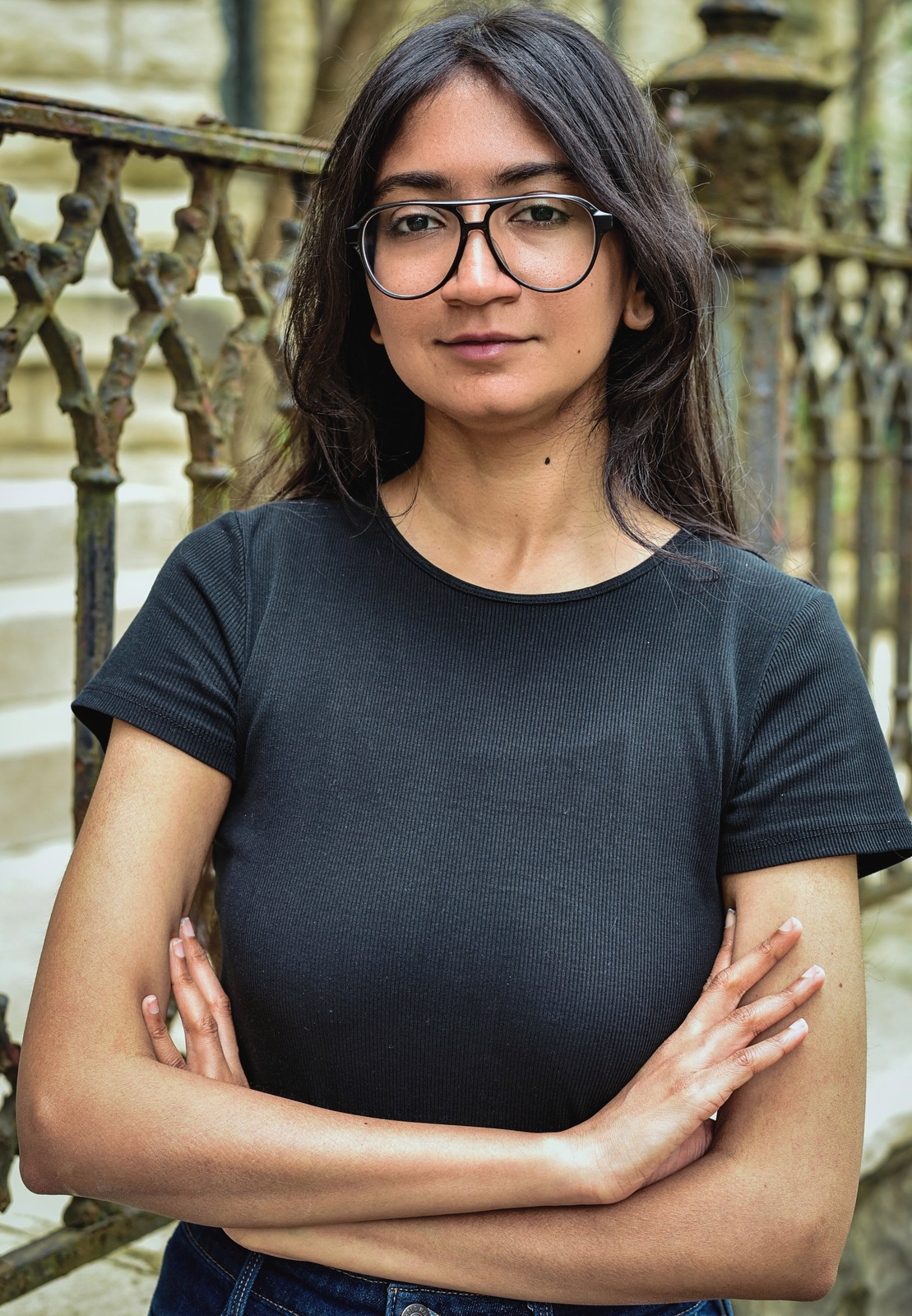 Divya Karthikeyan, Editorial Manager at Queer Kentucky, standing outdoors.