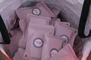 Reusable pink pouches filled with menstrual products labeled Period Y’all sit inside a tote bag as part of efforts to distribute free period supplies in Kentucky.