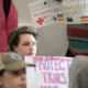 A person holds a Protect Trans Youth sign at the 2026 Fairness Rally in Kentucky.