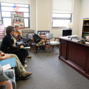 Advocates meet with a Kentucky lawmaker in his Frankfort office during the 2026 legislative session. A photographer documents the visit, which included a Martin Luther King Jr. tribute display and a "We Can Do It!" poster on the wall.